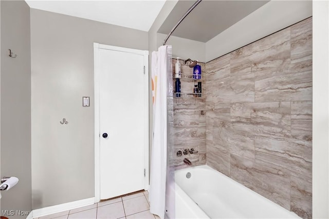 bathroom featuring baseboards, tile patterned flooring, and shower / tub combo with curtain