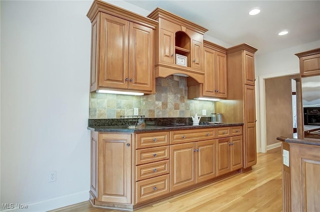 kitchen featuring tasteful backsplash, recessed lighting, light wood-style flooring, and baseboards