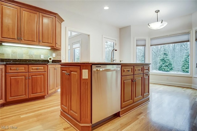 kitchen with brown cabinets, light wood-style flooring, tasteful backsplash, and stainless steel dishwasher