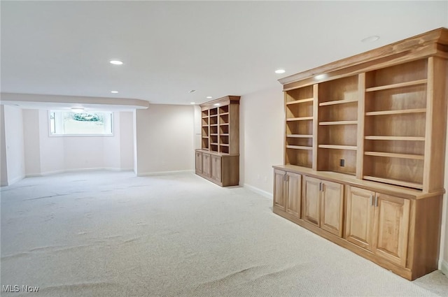 empty room with light carpet, baseboards, and recessed lighting