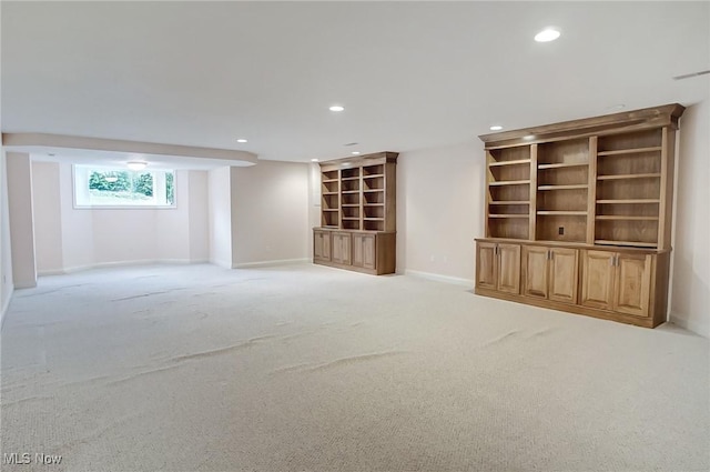 unfurnished room featuring recessed lighting, light carpet, and baseboards