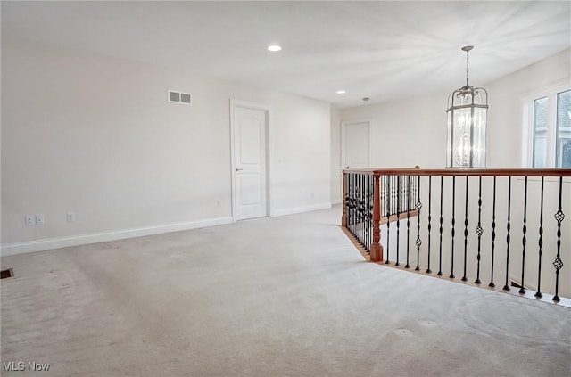 corridor featuring visible vents, baseboards, carpet floors, a chandelier, and recessed lighting