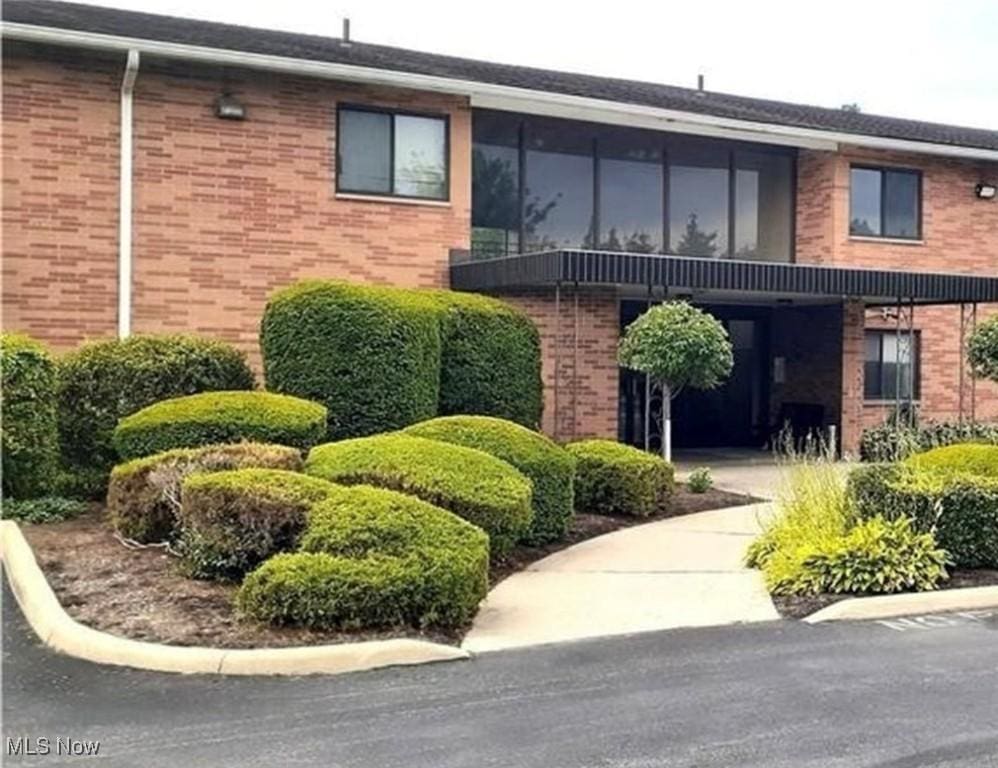 exterior space featuring brick siding