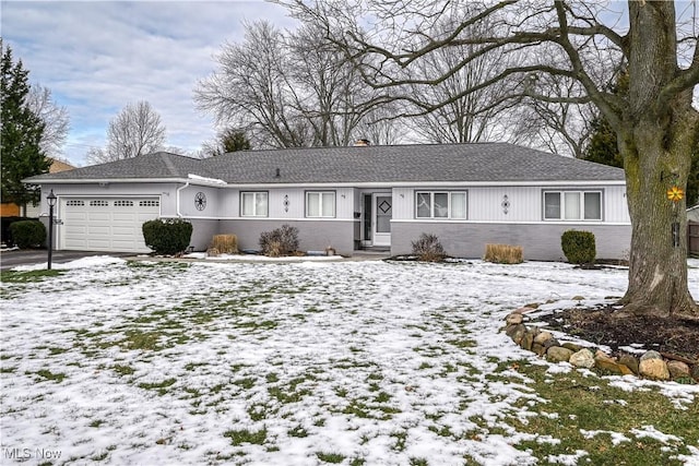 ranch-style home with entry steps, brick siding, driveway, and an attached garage