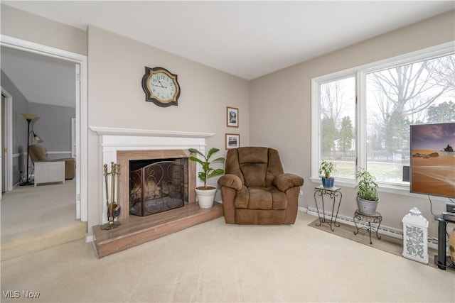 sitting room featuring carpet floors and a fireplace with raised hearth