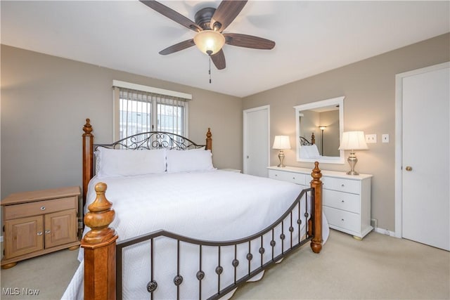 bedroom featuring light colored carpet and ceiling fan