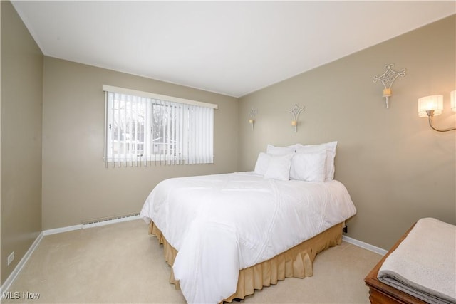 bedroom featuring light carpet, baseboards, and baseboard heating