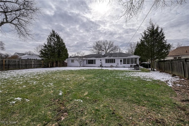 rear view of property featuring a fenced backyard, a yard, and a patio