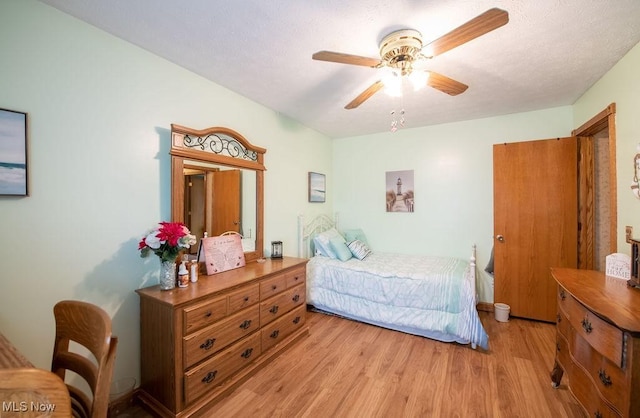 bedroom featuring light wood finished floors and ceiling fan