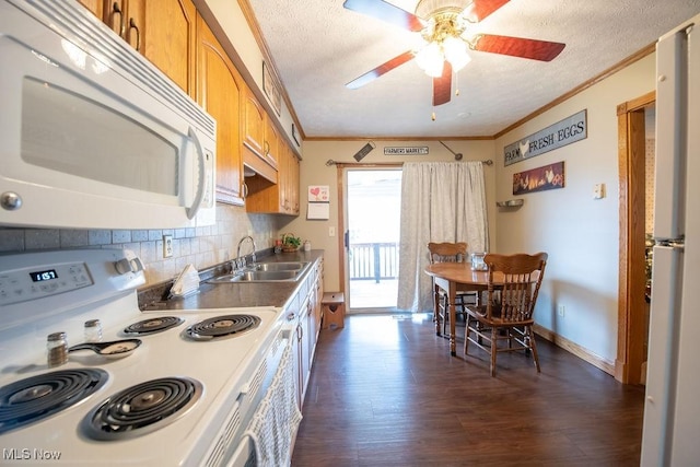 kitchen featuring white appliances, ornamental molding, backsplash, and a sink