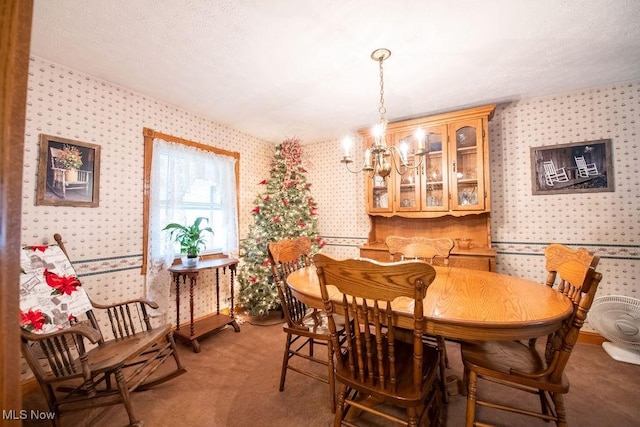 dining area featuring wallpapered walls, a notable chandelier, and light colored carpet