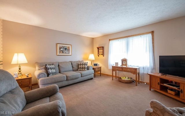 carpeted living room with a textured ceiling and baseboards