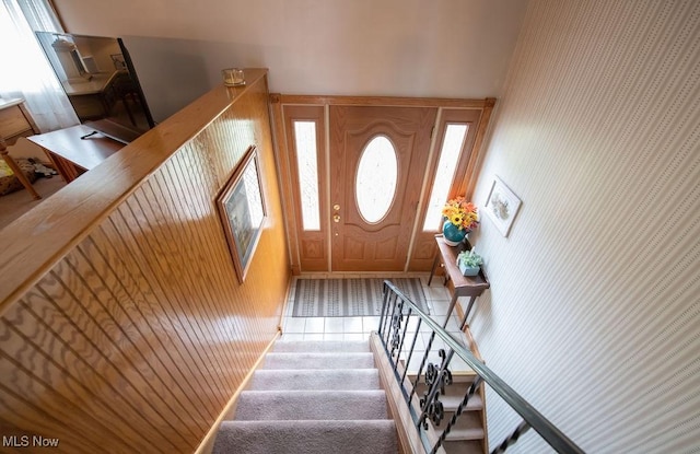 foyer with stairway and wallpapered walls