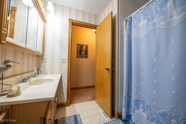 full bathroom featuring curtained shower, wallpapered walls, a textured ceiling, vanity, and tile patterned floors