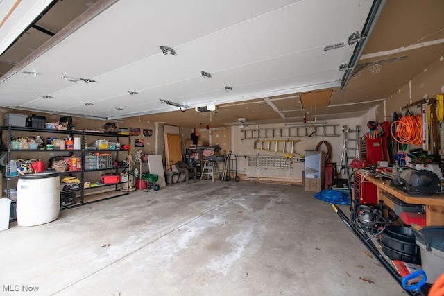 garage with a garage door opener and a workshop area