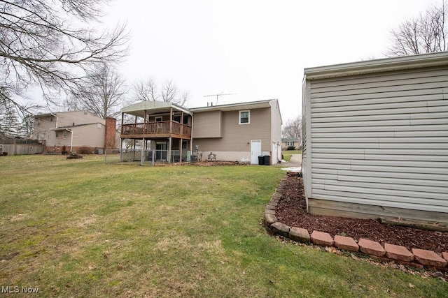 back of house featuring a yard and fence