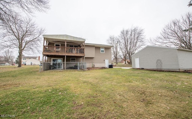 rear view of house featuring a yard and fence