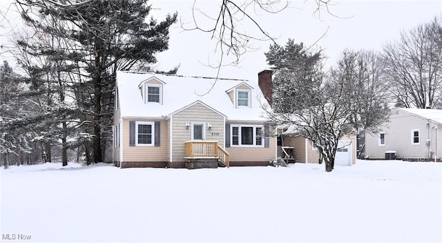 cape cod house featuring central AC and a chimney