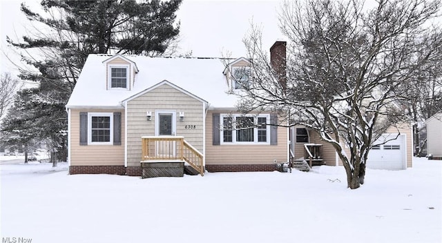 cape cod home with a garage and a chimney