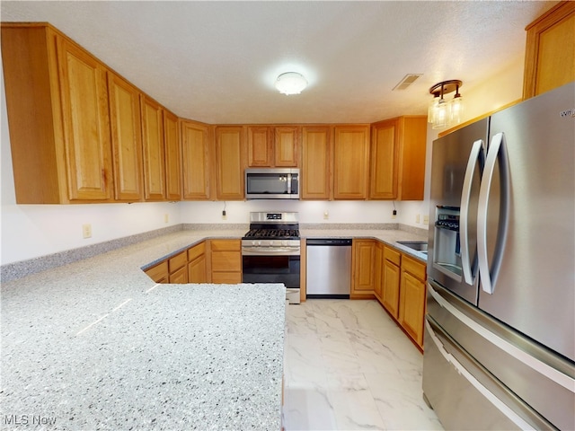 kitchen featuring stainless steel appliances, marble finish floor, light countertops, and visible vents