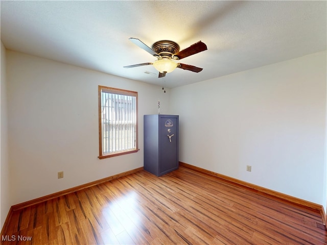 unfurnished room featuring baseboards, ceiling fan, and light wood finished floors