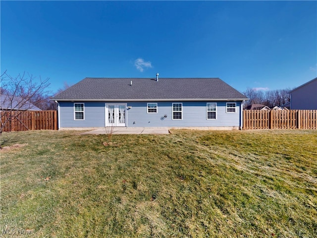 rear view of house with french doors, a lawn, a patio area, and a fenced backyard