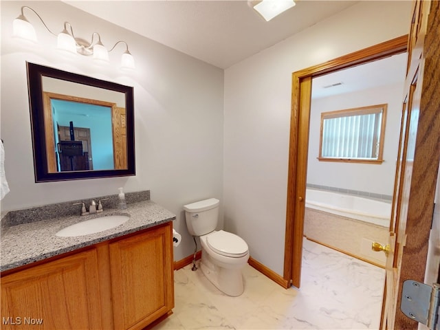 full bath with baseboards, vanity, toilet, and a bathing tub