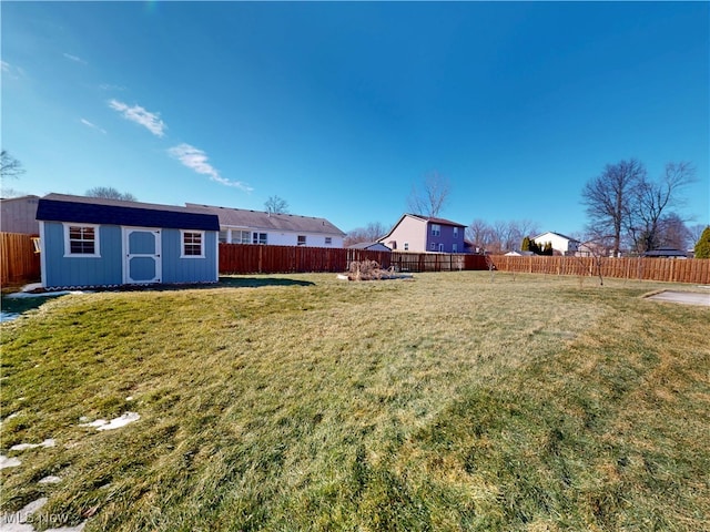 view of yard with a fenced backyard and an outdoor structure