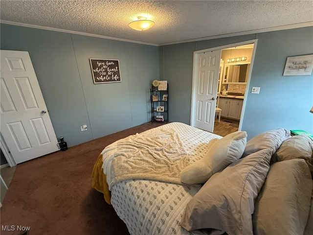 carpeted bedroom with connected bathroom, ornamental molding, and a textured ceiling