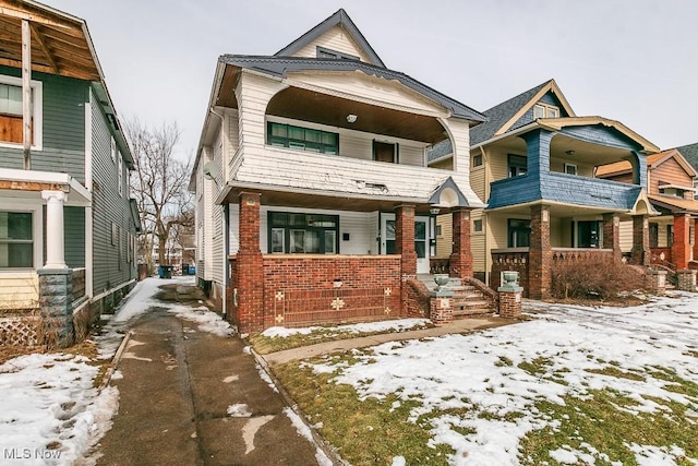 view of front of home with driveway and brick siding