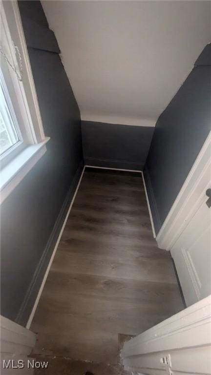 stairs featuring wood finished floors and baseboards