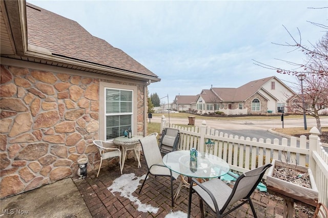 balcony featuring outdoor dining space, a patio, and a residential view