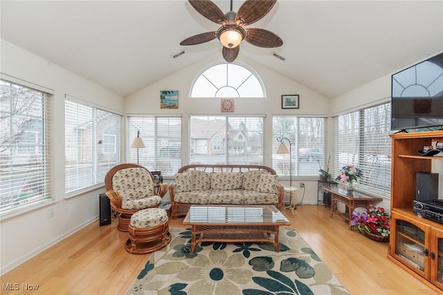 sunroom / solarium featuring plenty of natural light, visible vents, and vaulted ceiling