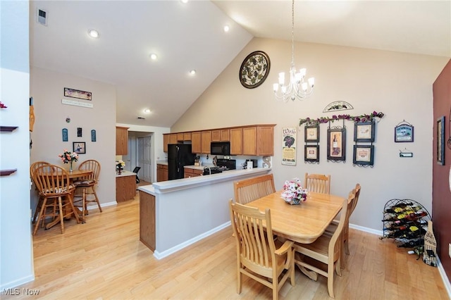 dining space featuring high vaulted ceiling, a notable chandelier, visible vents, baseboards, and light wood-style floors