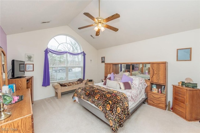 bedroom with visible vents, vaulted ceiling, a ceiling fan, and light colored carpet