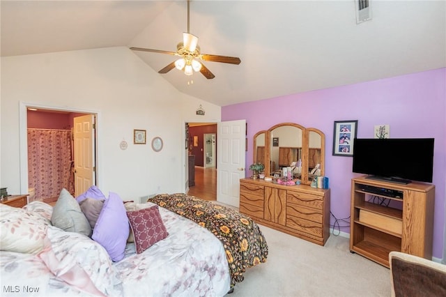 bedroom featuring a ceiling fan, light colored carpet, vaulted ceiling, and visible vents