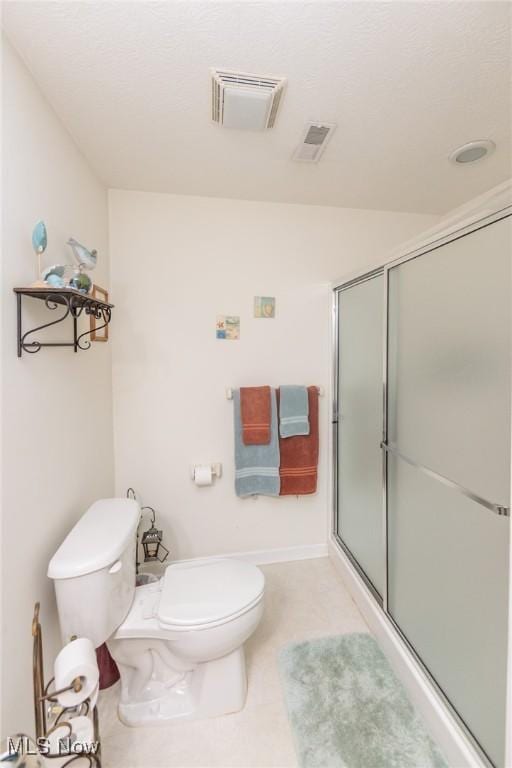 full bathroom featuring toilet, a stall shower, and visible vents