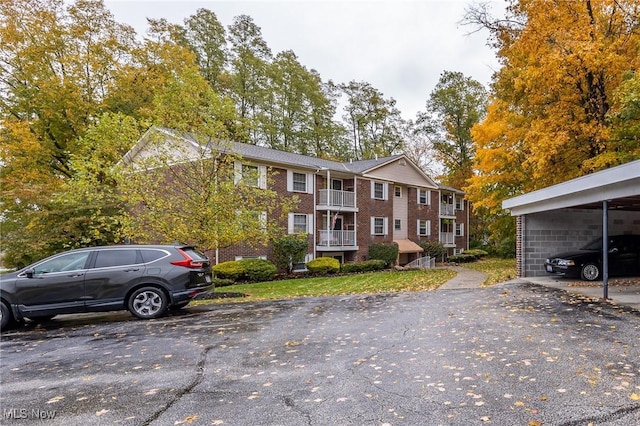 view of front of house featuring uncovered parking and brick siding