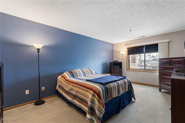 carpeted bedroom featuring visible vents, a textured ceiling, and baseboards