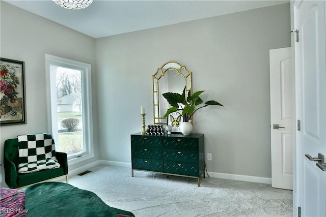 sitting room with carpet floors, visible vents, and baseboards