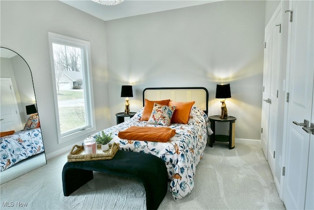 bedroom featuring carpet flooring, baseboards, and multiple windows