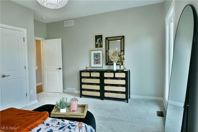 carpeted bedroom featuring visible vents and baseboards