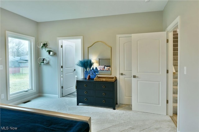 bedroom with light carpet, baseboards, and visible vents