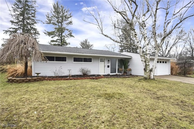 ranch-style home with a garage, a front lawn, and concrete driveway