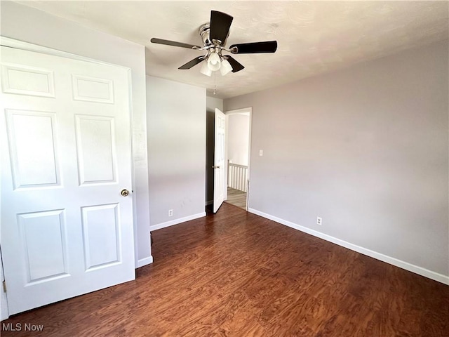 546 Rose St, Follansbee, WV 26037 - unfurnished bedroom with dark wood-style floors, ceiling fan, and baseboards