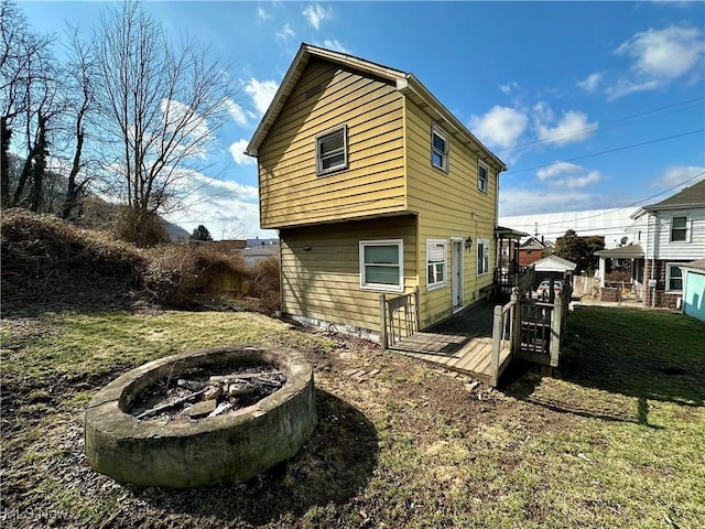 546 Rose St, Follansbee, WV 26037 - view of side of home with an outdoor fire pit, a lawn, and a wooden deck