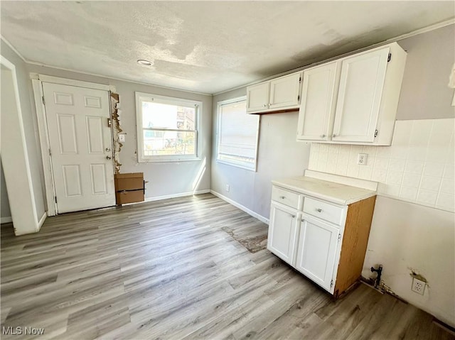 546 Rose St, Follansbee, WV 26037 - kitchen featuring light wood-style flooring, white cabinetry, light countertops, and backsplash