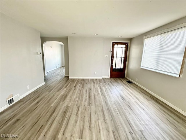 546 Rose St, Follansbee, WV 26037 - unfurnished living room featuring arched walkways, visible vents, and baseboards