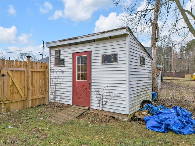 view of shed featuring fence