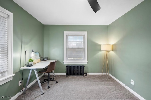 carpeted home office featuring baseboards and radiator